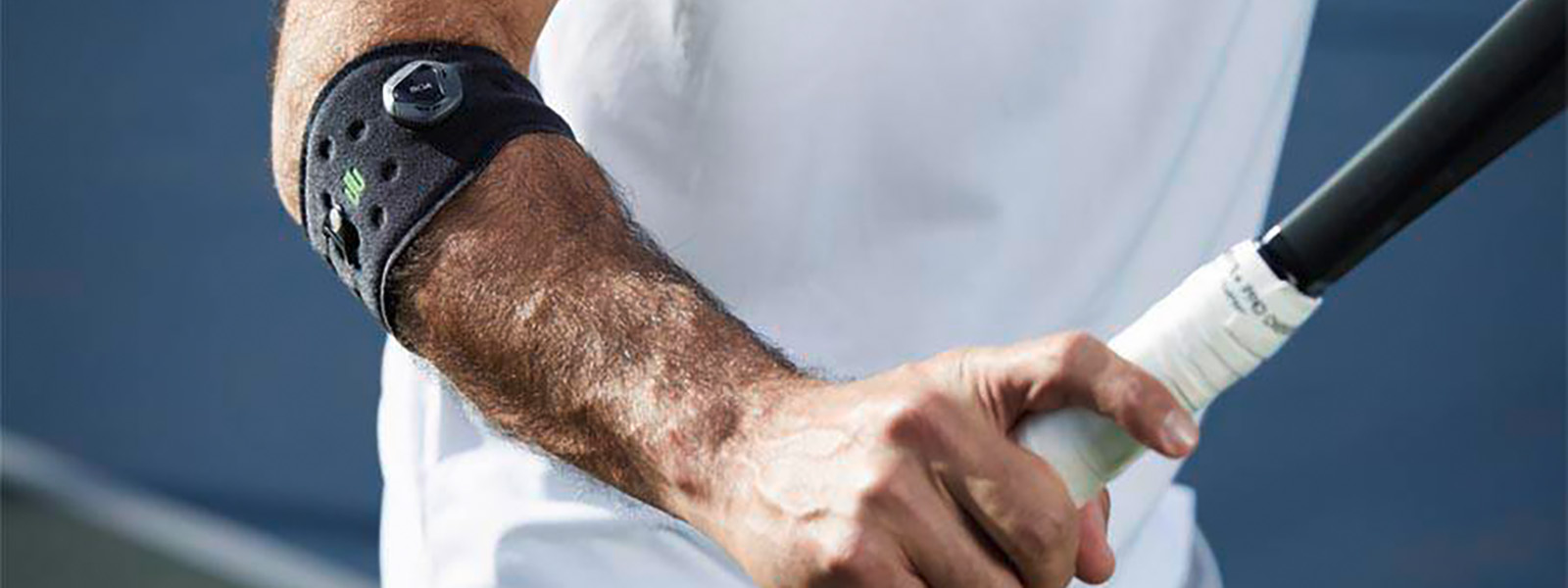 Le Sports Elbow Strap prévient le tennis elbow et soutient ton jeu de tennis Joueur de tennis avec bandage au coude tenant une raquette de tennis