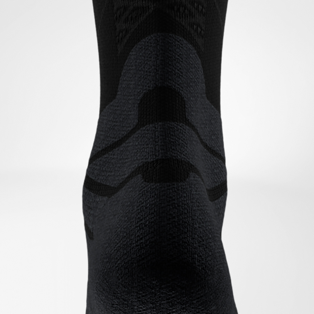 Detailansicht der schwarzen Run Performance Midcut Socke mit Achilles-Tendon-Comfort-Zone. Sichtbar sind die fein gearbeiteten Rippstrukturen im Bereich des Mittelfußes, die für Atmungsaktivität und Halt sorgen.