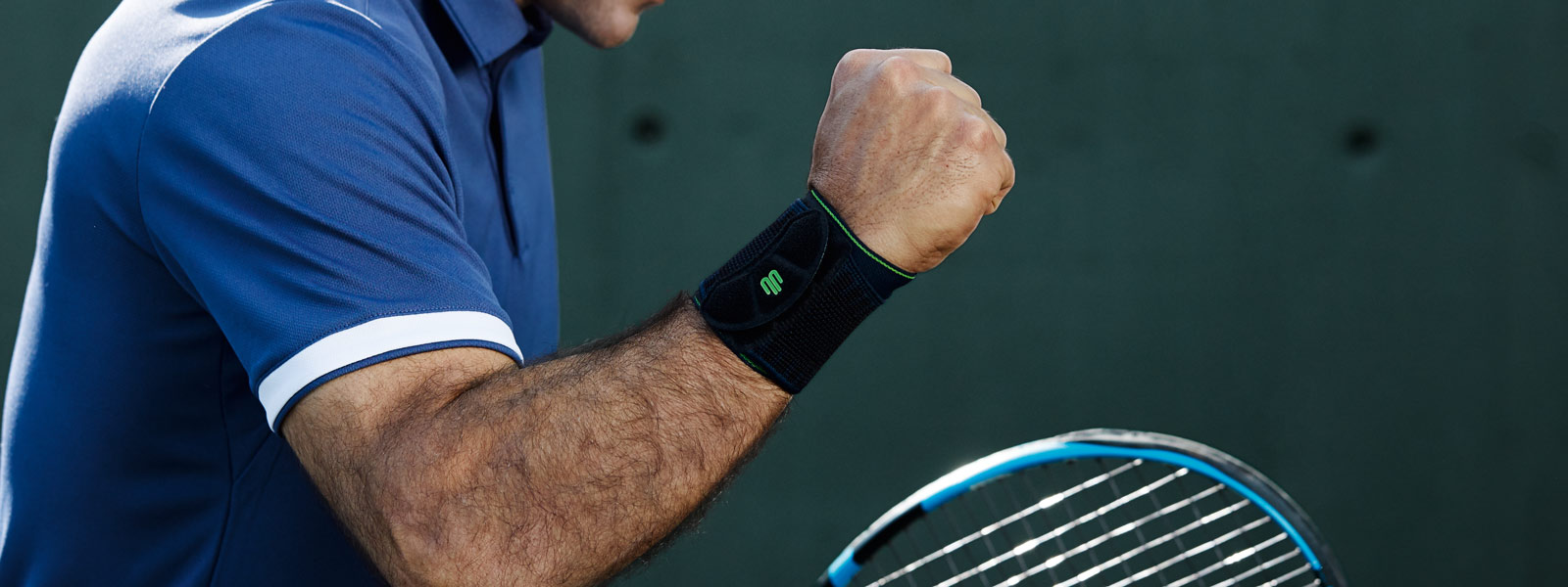 Mehr Power für die Handgelenke mit der Sports Wrist Support Tennisspieler mit schwarzer Handgelenkbandage ballt die Faust