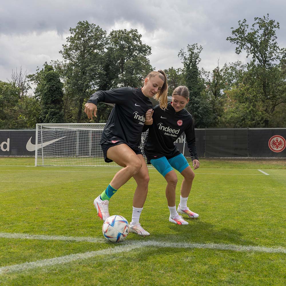 Protégez vos chevilles en jouant au foot - avec notre Ankle Support Une femme porte le Sports Ankle Support à rivera lors d'un duel sur un terrain en herbe
